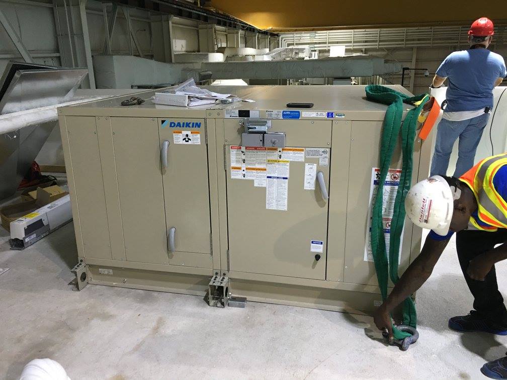 Crew prepping rigging on the new Daikin air handler before the lift