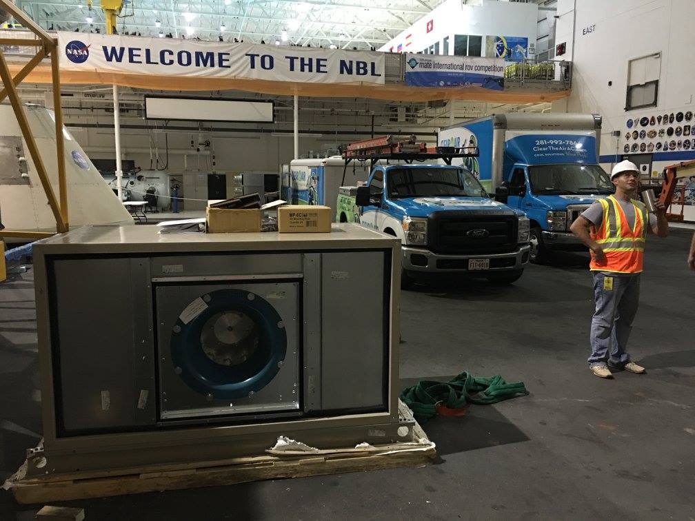 Clear the Air trucks staged inside the NBL high bay under the Welcome to the NBL banner